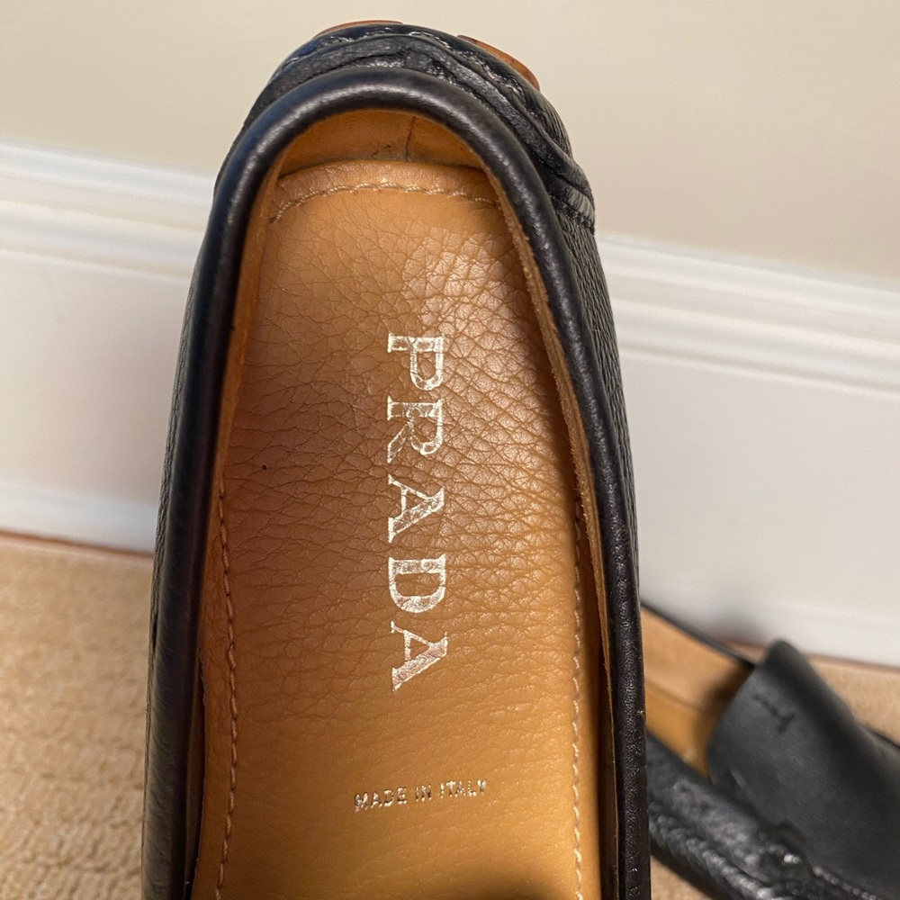 Lightly worn black leather Prada women’s loafers.